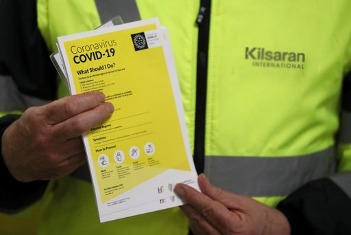 Kilsaran covid-19 statement man holding covid-19 leaflet